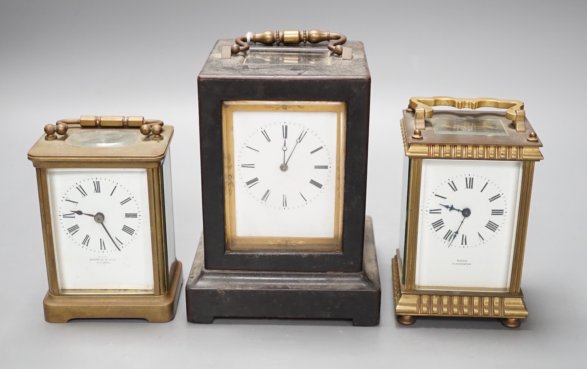 A mid 19th century French ebony veneered carriage clock, 16cm high with J. Cramp Horsham retailers label, a Mappin and Webb carriage clock, another by Mann of Gloucester, tallest 15cms high